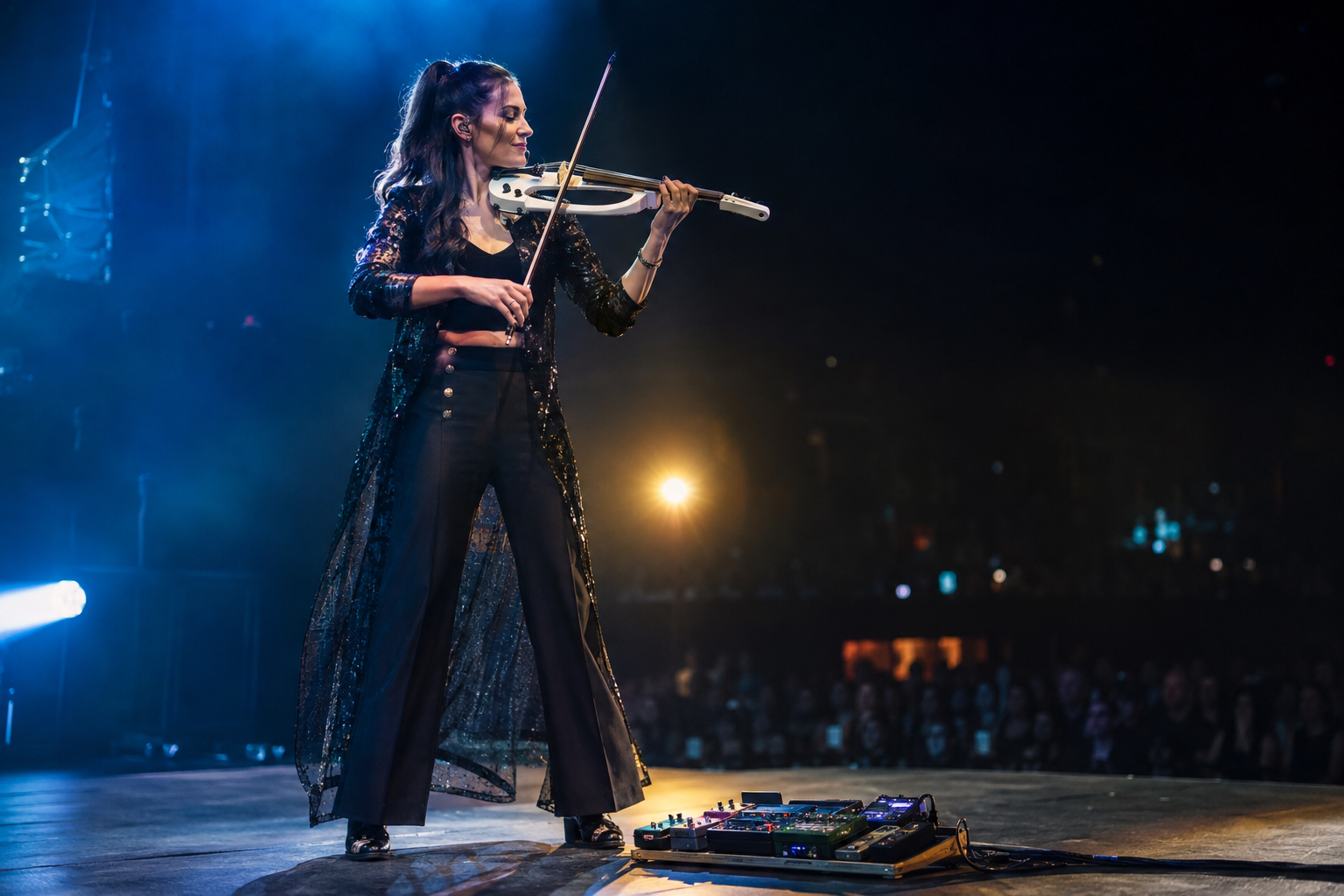 World-class electric violin performer on stage beside a compact pedalboard, using chorus for a wider live tone under blue and amber lights