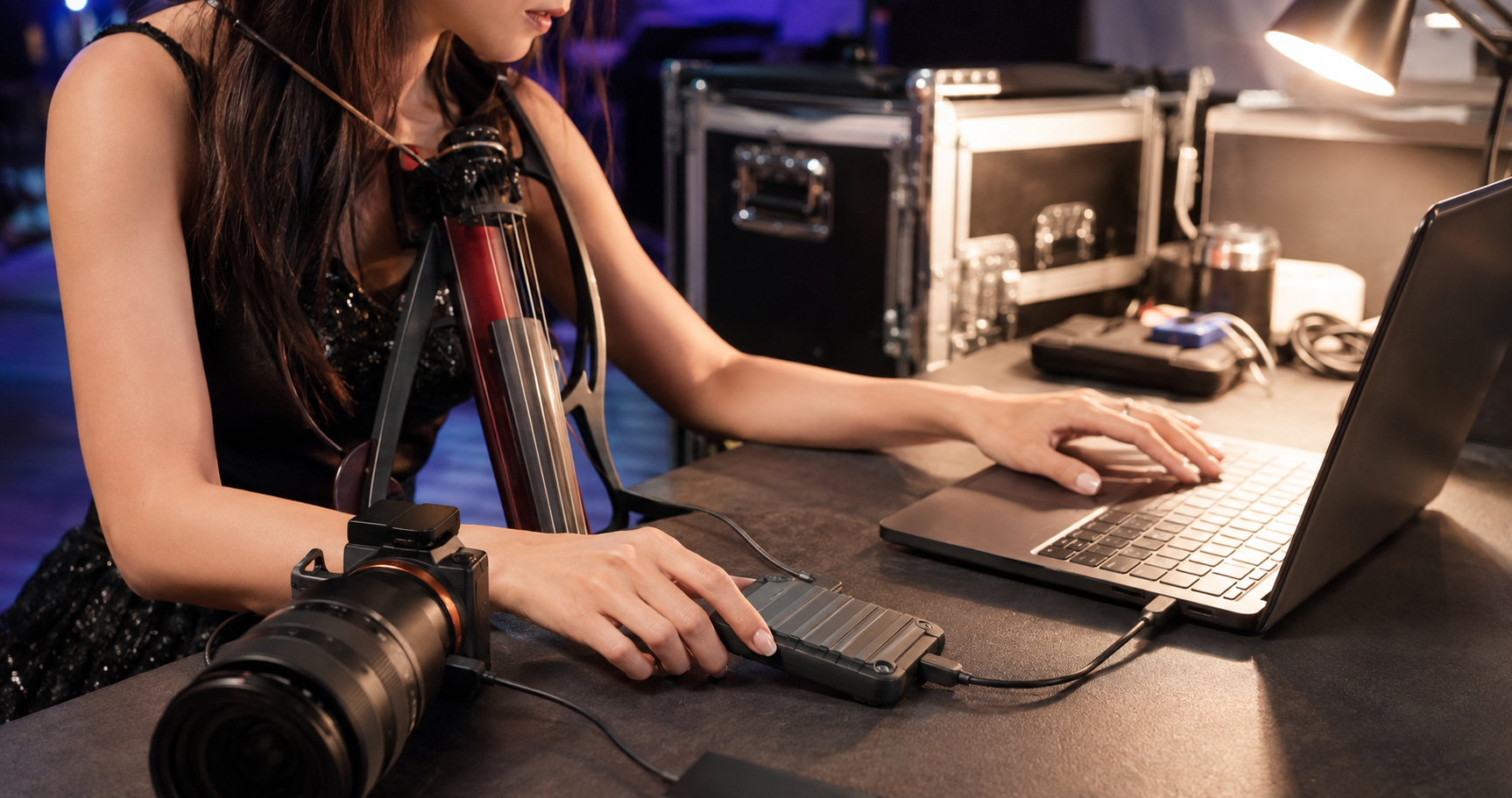 Electric violin content creator transferring concert camera footage to a rugged portable SSD